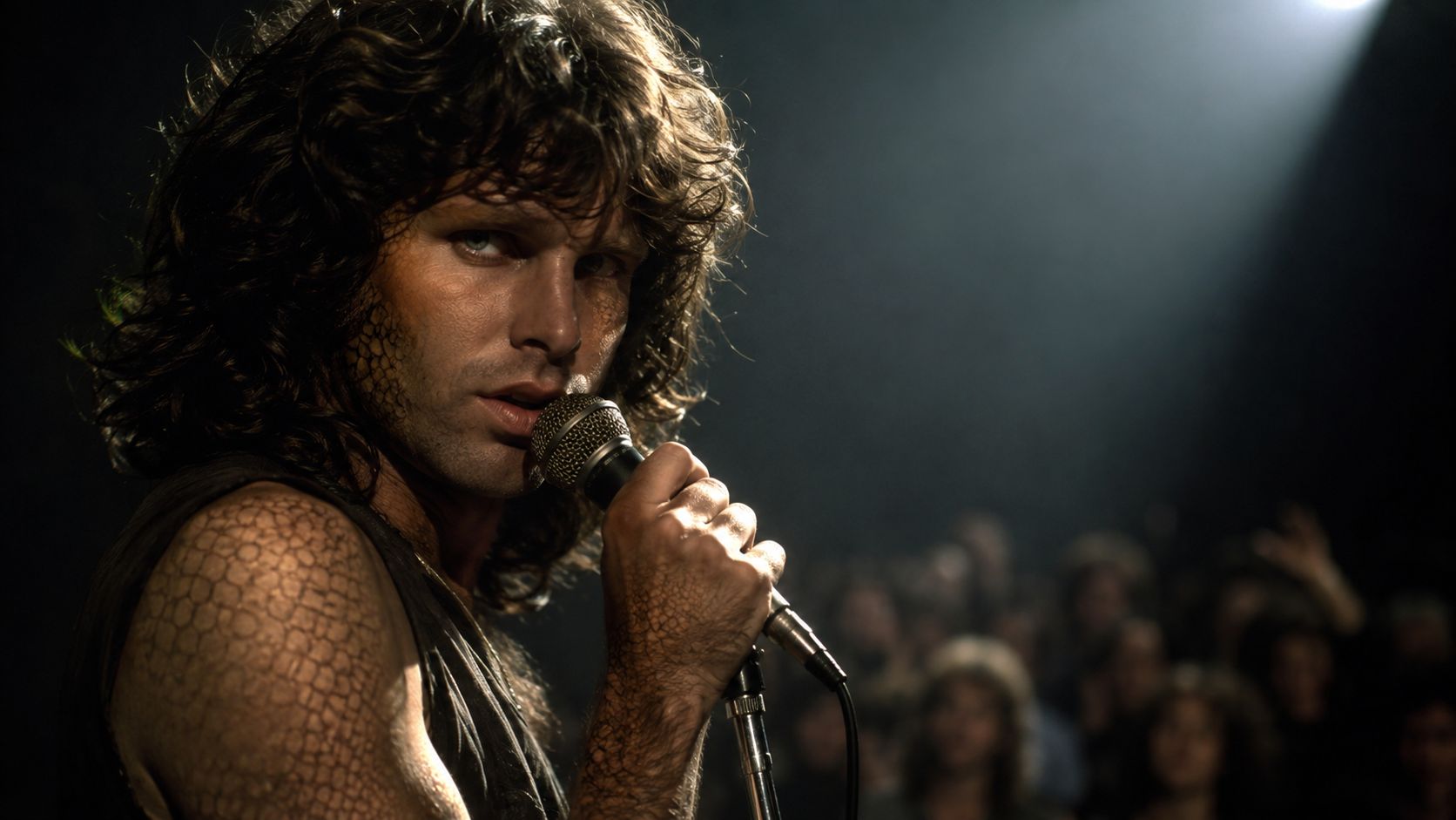 A close-up portrait of rock singer Jim Morrison holding a microphone during a dark concert performance.